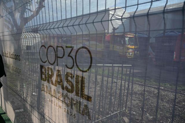 View of firefighters trucks from outside the COP30 UN Climate Change Conference in Belem, Para state, Brazil, on November 20, 2025, after a fire broke out in a pavilion. A fire erupted at a pavilion inside the venue of the UN's climate talks in Brazil on Thursday, prompting panicked delegates to run for the exits, AFP journalists said. Emergency crews rushed to try to put out the blaze as smoke engulfed the corridor. (Photo by Pablo PORCIUNCULA / AFP)