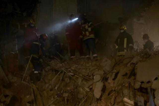 Ukrainian rescuers work at the site of a heavily damaged residential building following an air attack in Ternopil on November 20, 2025, amid the Russian invasion of Ukraine. Ukrainian president said on November 20, 2025 that 22 people were still missing in the western city of Ternopil, a day after a Russian strike there killed at least 26 people, including three children. (Photo by Vladyslav Musiienko / AFP)