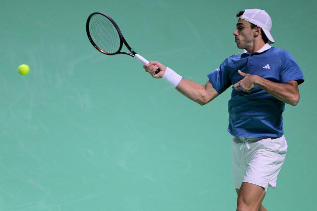 Argentina's Francisco Cerundolo returns the ball to Germany's Alexander Zverev during the Davis Cup men's singles quarter finals tennis match, at the Super Tennis Arena, in Bologna, northen Italy, on November 20, 2025. (Photo by Tiziana FABI / AFP)