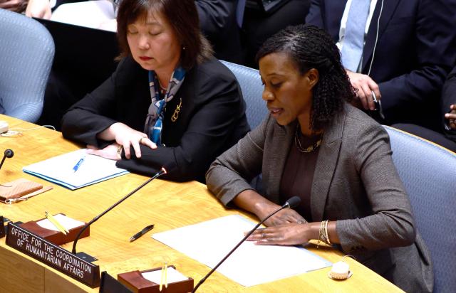 Edem Wosornu (R), Director of the Crisis Response Division, Office for the Coordination of Humanitarian Affairs (OCHA), speaks during a UN Security Council meeting on Ukraine at the UN Headquarters in New York City, November 20, 2025. (Photo by kena betancur / AFP)