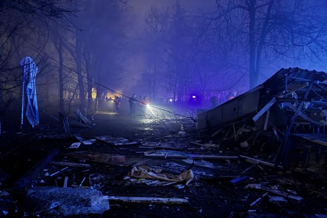 Rescuers and Ukrainian law enforcement officers work at the site of an air attack in Zaporizhzhia, on November 20, 2025, amid the Russian invasion of Ukraine. (Photo by Darya NAZAROVA / AFP)