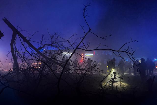 Rescuers and Ukrainian law enforcement officers work at the site of an air attack in Zaporizhzhia, on November 20, 2025, amid the Russian invasion of Ukraine. (Photo by Darya NAZAROVA / AFP)