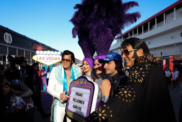 Williams' Spanish driver Carlos Sainz poses for a photo with Elvis Presley impersonators and performers before the start of the first practice session for the Las Vegas Formula One Grand Prix at the Las Vegas Strip Circuit in Las Vegas, Nevada, on November 20, 2025. (Photo by Patrick T. Fallon / AFP)