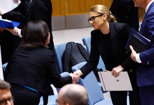Ambassador Khrystyna Hayovyshyn (R), Permanent Representative of Ukraine to the UN, shakes hands with Kayoko Gotoh, Officer-in-Charge of the Europe, Central Asia and Americas Division, during a UN Security Council meeting on Ukraine at the UN Headquarters in New York City, November 20, 2025. (Photo by kena betancur / AFP)