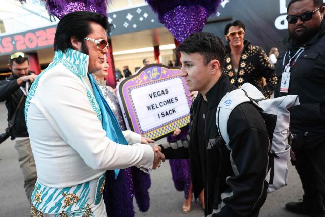 RB's French driver Isack Hadjar is greeted by an Elvis Presley impersonator as he arrives ahead of the first practice session for the Las Vegas Formula One Grand Prix at the Las Vegas Strip Circuit in Las Vegas, Nevada, on November 20, 2025. (Photo by Patrick T. Fallon / AFP)