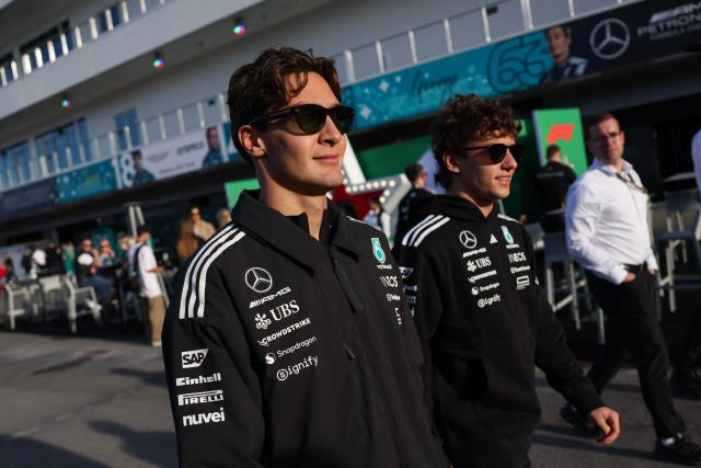 (L/R) Mercedes' British driver George Russell and Mercedes' Italian driver Kimi Antonelli walk in the paddock ahead of the first practice session for the Las Vegas Formula One Grand Prix at the Las Vegas Strip Circuit in Las Vegas, Nevada, on November 20, 2025. (Photo by Patrick T. Fallon / AFP)