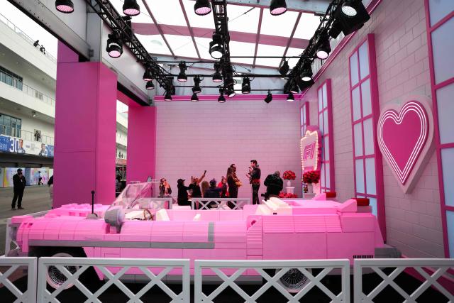 A couple renews their wedding vows with an Elvis Presley impersonator at the "F1 Neon Wedding Chapel" ahead of the first practice session for the Las Vegas Formula One Grand Prix at the Las Vegas Strip Circuit in Las Vegas, Nevada, on November 20, 2025. (Photo by Patrick T. Fallon / AFP)