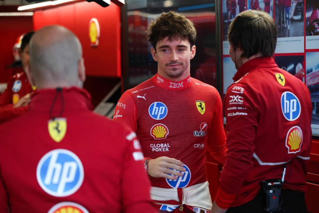 Ferrari's Monegasque driver Charles Leclerc speaks with teammates in the garage during the first practice session for the Las Vegas Formula One Grand Prix at the Las Vegas Strip Circuit in Las Vegas, Nevada, on November 20, 2025. (Photo by Patrick T. Fallon / AFP)