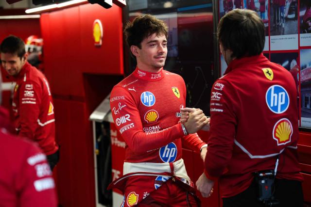 Ferrari's Monegasque driver Charles Leclerc greets teammates in the garage during the first practice session for the Las Vegas Formula One Grand Prix at the Las Vegas Strip Circuit in Las Vegas, Nevada, on November 20, 2025. (Photo by Patrick T. Fallon / AFP)