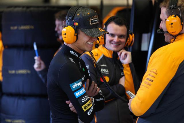 McLaren's British driver Lando Norris (L) speaks with teammates in the garage during the first practice session for the Las Vegas Formula One Grand Prix at the Las Vegas Strip Circuit in Las Vegas, Nevada, on November 20, 2025. (Photo by Patrick T. Fallon / AFP)