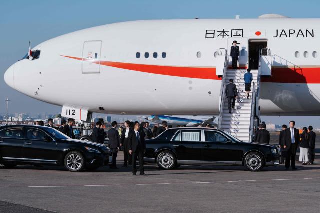 Japan's Prime Minister Sanae Takaichi boards a plane as she departs for the G20 leaders' Summit in South Africa, at Tokyo's Haneda Airport on November 21, 2025. (Photo by Kazuhiro NOGI / AFP)
