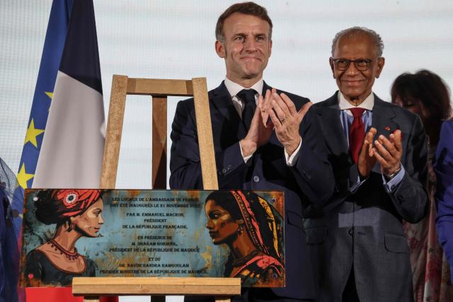 France’s President Emmanuel Macron (L) and Mauritius' Prime Minister Navin Ramgoolam (R) applaud during the inauguration ceremony of the Mauritius French Embassy in Port Louis on November 21, 2025. (Photo by Ludovic MARIN / AFP)