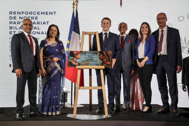 (From L to R): Mauritius' President Dharam Gokhool and First Lady of Mauritius Vrinda Gokhool, France’s President Emmanuel Macron, Mauritius' Prime Minister Navin Ramgoolam and his wife Veena Ramgoolam and French Ambassador of France to Mauritius Frederic Bontems (R), pose for a photograph during the inauguration ceremony of the Mauritius French Embassy in Port Louis on November 21, 2025. (Photo by Ludovic MARIN / AFP)