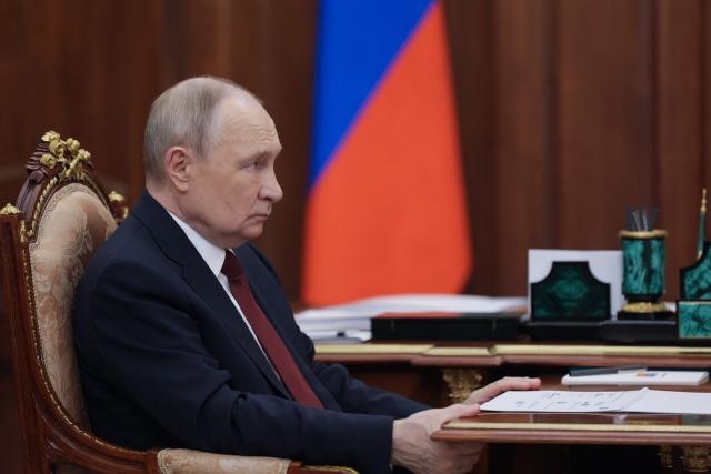 In this pool photograph distributed by the Russian state agency Sputnik, Russia's President Vladimir Putin attends a meeting with the Head of the Federal Tax Service (FTS) in Moscow on November 21, 2025. (Photo by Gavriil Grigorov / POOL / AFP)