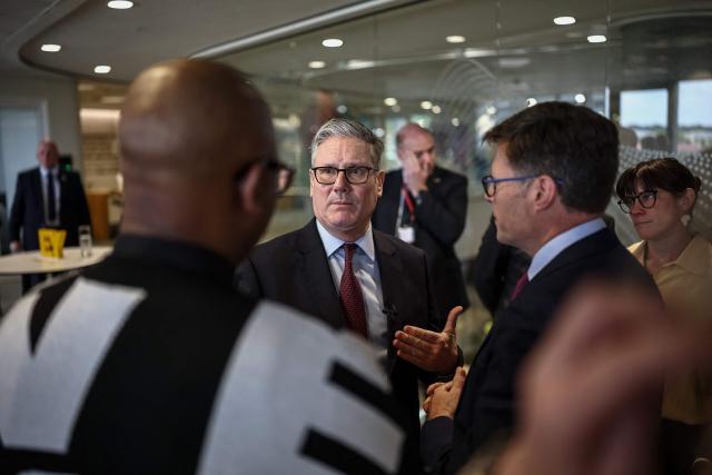 Britain's Prime Minister Keir Starmer (C) speaks to business leaders EY headquarters in Johannesburg, on November 21, 2025 ahead of the G20 leaders' Summit. (Photo by HENRY NICHOLLS / POOL / AFP)