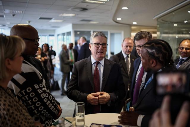 Britain's Prime Minister Keir Starmer (C) speaks to business leaders at the EY headquarters in Johannesburg, on November 21, 2025 ahead of the G20 leaders' Summit. (Photo by HENRY NICHOLLS / POOL / AFP)