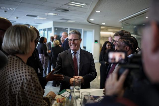 Britain's Prime Minister Keir Starmer (C) speaks to business leaders at the EY headquarters in Johannesburg, on November 21, 2025 ahead of the G20 leaders' Summit. (Photo by HENRY NICHOLLS / POOL / AFP)