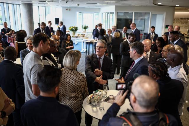 Britain's Prime Minister Keir Starmer (C) speaks to business leaders EY headquarters in Johannesburg, on November 21, 2025 ahead of the G20 leaders' Summit. (Photo by HENRY NICHOLLS / POOL / AFP)