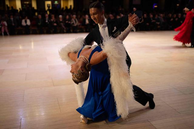 Ballroom dancers Mykhailo Bokii and Olivia King compete in the 'North of England Amateur Ballroom' discipline of the 50th British National Dance Championships, in the Empress Ballroom of Blackpool's Winter Gardens, in Blackpool, north-west England, on November 20, 2025. The annual, four-day British National Dance Championship features over 2000 entries and showcases 60 hours of competitive dancing, with 23 championship titles in Ballroom and Latin dance disciplines. (Photo by Oli SCARFF / AFP)