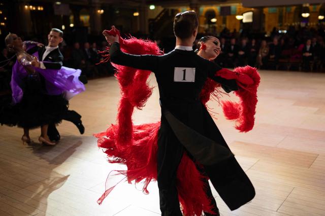 Ballroom dancing couple Oliver Johnson and Sophie Heyworth compete in the 'North of England Amateur Ballroom' discipline of the 50th British National Dance Championships, in the Empress Ballroom of Blackpool's Winter Gardens, in Blackpool, north-west England, on November 20, 2025. The annual, four-day British National Dance Championship features over 2000 entries and showcases 60 hours of competitive dancing, with 23 championship titles in Ballroom and Latin dance disciplines. (Photo by Oli SCARFF / AFP)
