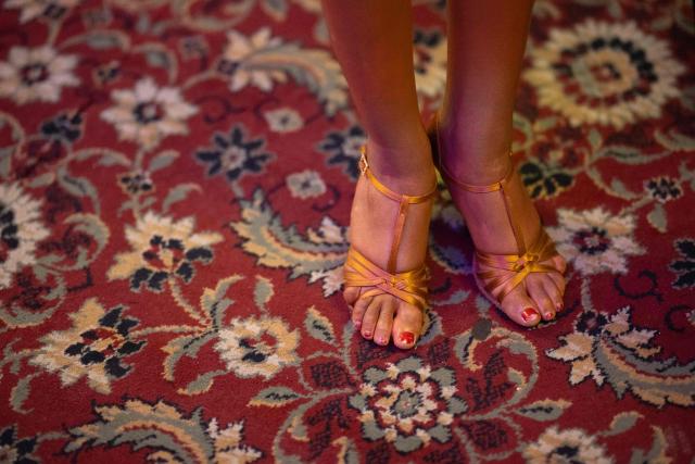 A Latin dancer waits on the carpet surrounding the dancefloor at the 50th British National Dance Championships, in the Empress Ballroom of Blackpool's Winter Gardens, in Blackpool, north-west England, on November 20, 2025. The annual, four-day British National Dance Championship features over 2000 entries and showcases 60 hours of competitive dancing, with 23 championship titles in Ballroom and Latin dance disciplines. (Photo by Oli SCARFF / AFP)