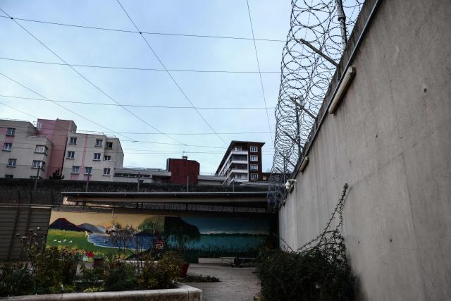 This photograph taken on November 21, 2025, shows one of the courtyards of the Sante prison, and residential apartment complexes in the background, in Paris on November 21, 2025. (Photo by Thibaud MORITZ / AFP)