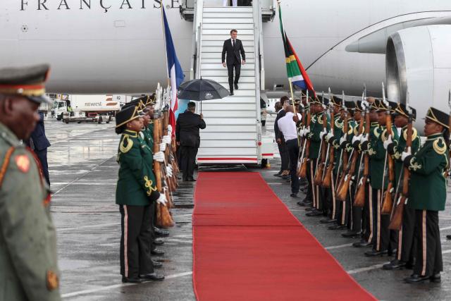 France’s President Emmanuel Macron (C) disembarks the plane upon his arrival at the OR Tambo International airport in Ekurhuleni on November 21, 2025 ahead of the G20 leader's Summit. (Photo by Ludovic MARIN / AFP)