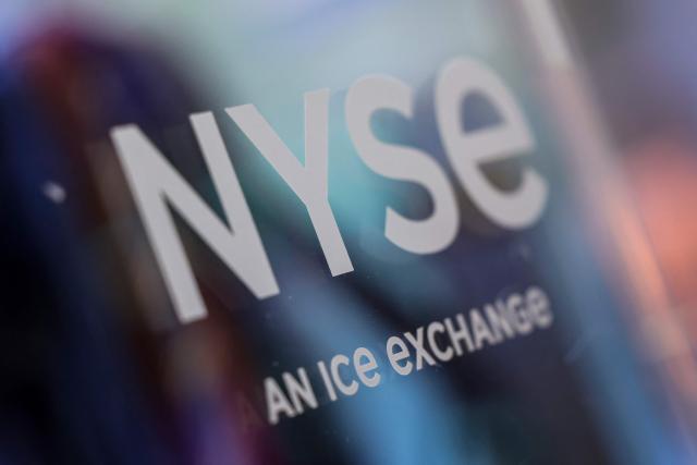 A sign reading "NYSE" is displayed at the New York Stock Exchange (NYSE) in New York on November 21, 2025. Wall Street stocks rebounded early Friday after a Federal Reserve official's remarks reignited hopes of a third consecutive US interest rate cut in December. (Photo by ANGELA WEISS / AFP)