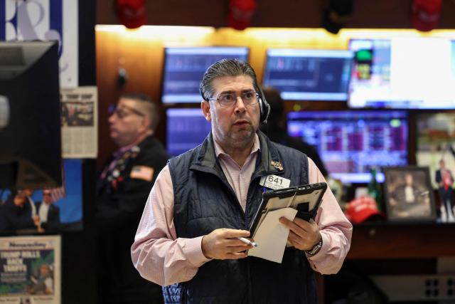 Traders work on the floor of the New York Stock Exchange (NYSE) in New York on November 21, 2025. Wall Street stocks rebounded early Friday after a Federal Reserve official's remarks reignited hopes of a third consecutive US interest rate cut in December. (Photo by ANGELA WEISS / AFP)