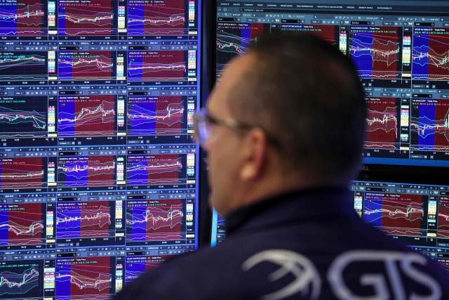 A Trader works on the floor of the New York Stock Exchange (NYSE) in New York on November 21, 2025. Wall Street stocks rebounded early Friday after a Federal Reserve official's remarks reignited hopes of a third consecutive US interest rate cut in December. (Photo by ANGELA WEISS / AFP)