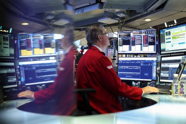 A Trader works on the floor of the New York Stock Exchange (NYSE) in New York on November 21, 2025. Wall Street stocks rebounded early Friday after a Federal Reserve official's remarks reignited hopes of a third consecutive US interest rate cut in December. (Photo by ANGELA WEISS / AFP)