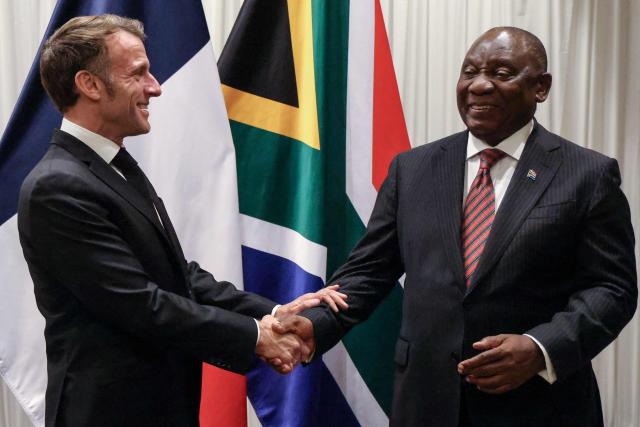 France’s President Emmanuel Macron (L) shakes hands with South Africa's President Cyril Ramaphosa (R) during their bilateral meeting at the Sandton Convention Centre in Sandton on November 21, 2025, ahead of the G20 leaders' Summit. (Photo by Ludovic MARIN / POOL / AFP)