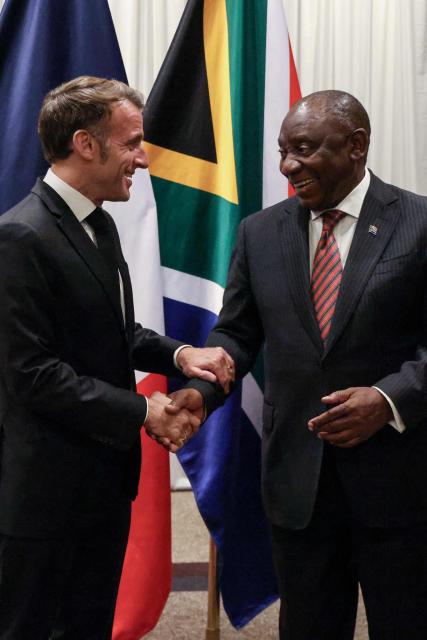 France’s President Emmanuel Macron (L) shakes hands with South Africa's President Cyril Ramaphosa (R) during their bilateral meeting at the Sandton Convention Centre in Sandton on November 21, 2025, ahead of the G20 leaders' Summit. (Photo by Ludovic MARIN / POOL / AFP)