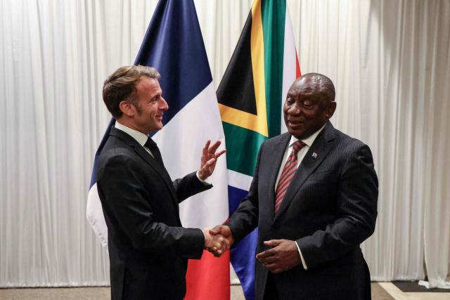 France’s President Emmanuel Macron (L) shakes hands with South Africa's President Cyril Ramaphosa (R) during their bilateral meeting at the Sandton Convention Centre in Sandton on November 21, 2025, ahead of the G20 leaders' Summit. (Photo by Ludovic MARIN / POOL / AFP)