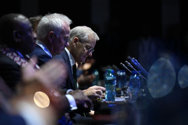 Norway's Prime Minister Jonas Gahr Store listens during the Global Fund’s Eighth Replenishment Summit at the Sandton Convention Centre in Sandton on November 21, 2025, ahead of the G20 leaders' Summit. (Photo by Leon Neal / POOL / AFP)