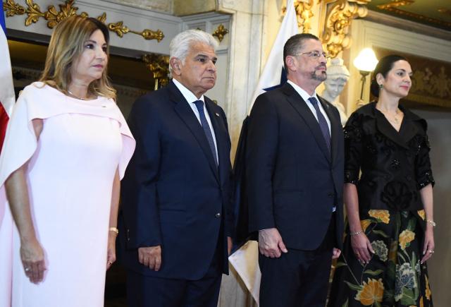 Panama's First Lady Maricel Cohen de Mulino, Panama's President Jose Raul Mulino, Costa Rica's President Rodrigo Chaves and Costa Rica's First Lady Signe Zeikate attend an event at the National Theater in San Jose, on November 21, 2025. (Photo by EZEQUIEL BECERRA / AFP)