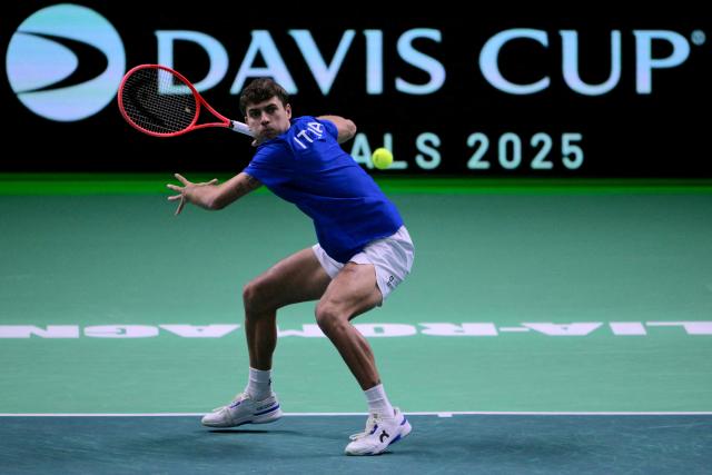 Italy's Flavio Cobolli hits a return during his 2025 Davis Cup semi-final single tennis match between Italy and Belgium at the Super Tennis Arena in Bologna, northen Italy, on November 21, 2025. (Photo by Tiziana FABI / AFP)