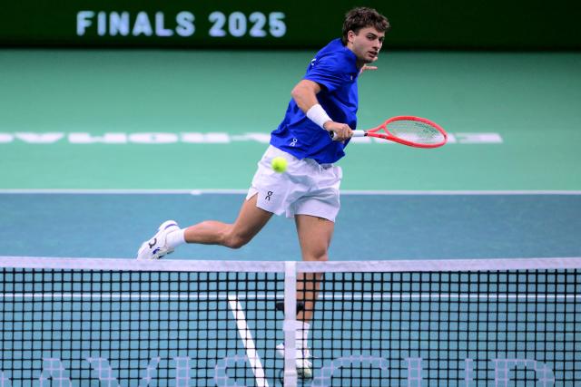 Italy's Flavio Cobolli hits a return during his 2025 Davis Cup semi-final single tennis match between Italy and Belgium at the Super Tennis Arena in Bologna, northen Italy, on November 21, 2025. (Photo by Tiziana FABI / AFP)