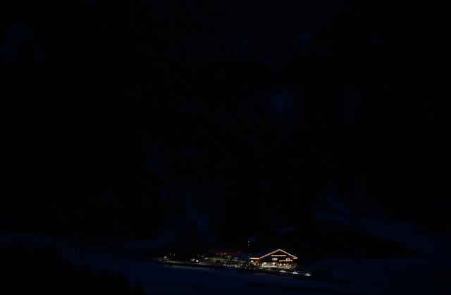 This photograph shows a mountain cottage illuminated in Cortina D'Ampezzo, ahead of Milano Cortina 2026 Olympic Games  on November 21, 2025. (Photo by Stefano RELLANDINI / AFP)