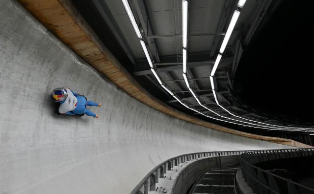 Italy's athlete competes in the skeleton mixed team race at the IBSF Bobsleigh and Skeleton World Cup during Milano Cortina 2026 Olympic Games test event in Cortina on November 21, 2025. (Photo by Stefano RELLANDINI / AFP)
