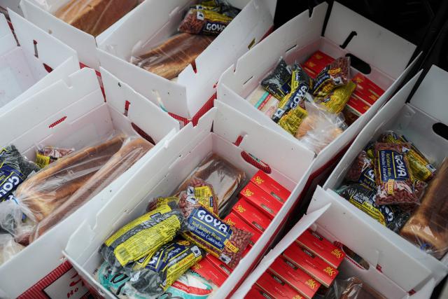 Boxes of food containing beans, bread and stuffing mix are seen during a Thanksgiving food distribution event outside of Brooklyn Borough Hall on November 21, 2025 in New York City. Fresh produce, non-perishables and other food items were handed out to 125 Brooklyn houses of worship, community kitchens and other community-based organizations addressing food insecurity and homelessness. (Photo by ANGELA WEISS / AFP)