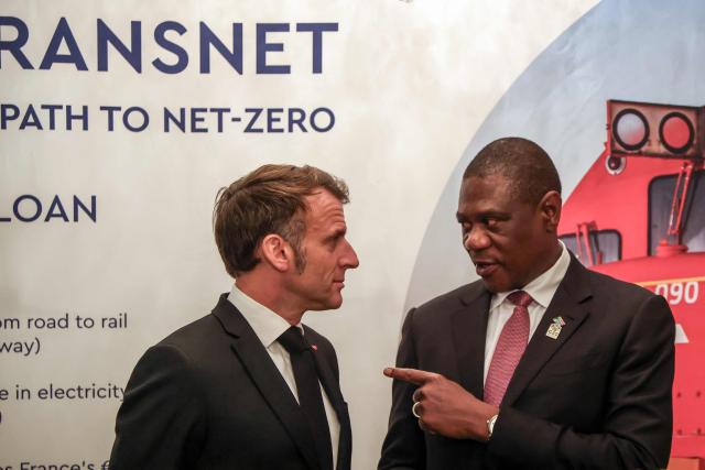 France’s President Emmanuel Macron (L) speaks with South Africa's Deputy President Paul Mashatile (R) at the launch of the Franco-South African Business Council, at the French Ambassador to South Africa's residence in Pretoria on November 21, 2025 ahead of the G20 leaders' Summit. (Photo by Ludovic MARIN / AFP)