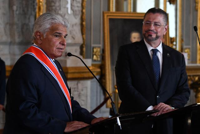Panama's President Jose Raul Mulino (L) speaks after being decorated with the Juan Mora Fernandez National Order by Costa Rica's President Rodrigo Chaves during a ceremony at the National Theater in San Jose, on November 21, 2025. (Photo by EZEQUIEL BECERRA / AFP)