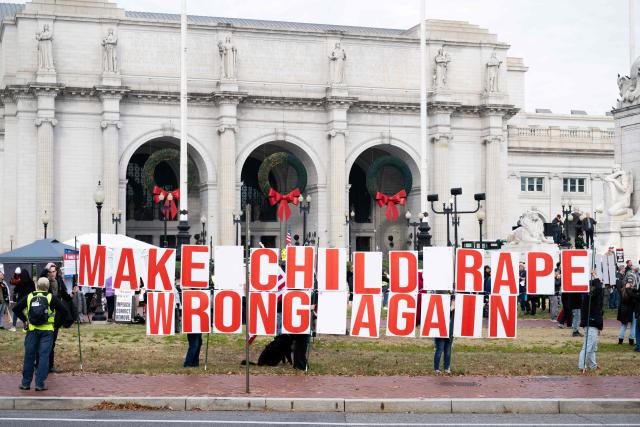 Demonstrators hold signs during the Veterans' Rally as part of the "Remove the Regime" protests against US President Donald Trump at Union Station near the US Capitol in Washington, DC, on November 21, 2025. The "Remove the Regime" protests are convened by The Removal Coalition, an umbrella group composed of several activist organizations. (Photo by SAUL LOEB / AFP)