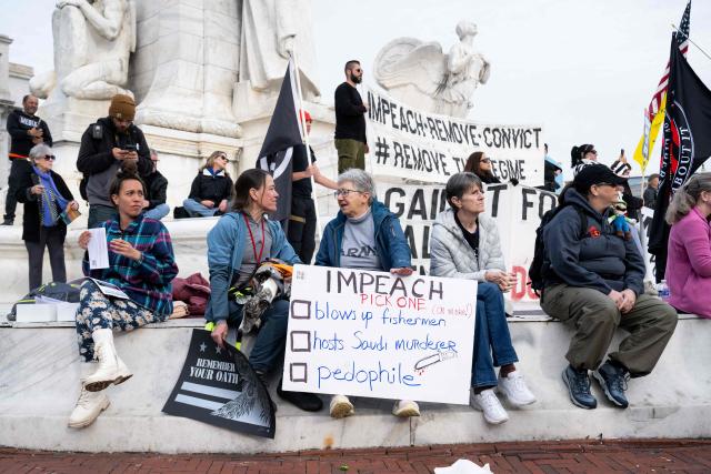 Demonstrators hold signs and flags during the Veterans' Rally as part of the "Remove the Regime" protests against US President Donald Trump at Union Station near the US Capitol in Washington, DC, on November 21, 2025. The "Remove the Regime" protests are convened by The Removal Coalition, an umbrella group composed of several activist organizations. (Photo by SAUL LOEB / AFP)