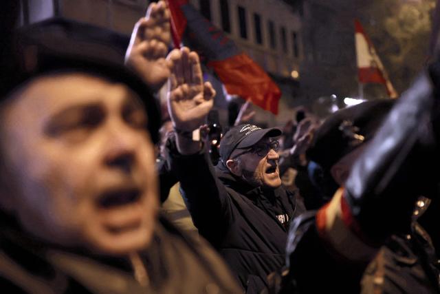 Demonstrators perform the fascist salute during a demonstration called by Falange Espanola de las JONS fascist party in Madrid, on November 21, 2025, marking the 50th anniversary of Spanish dictator Francisco Franco's death. Prime Minister Pedro Sanchez yesterday called on Spaniards to defend the "miracle" of their democracy as the divided country marked the 50th anniversary of ex-dictator Francisco Franco's death. The general's demise on November 20, 1975 ended 36 years of authoritarian right-wing rule that followed a devastating 1936-1939 civil war which brought him to power. (Photo by Oscar DEL POZO / AFP)