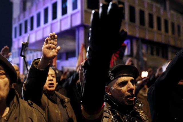 Demonstrators perform the fascist salute during a demonstration called by Falange Espanola de las JONS fascist party in Madrid, on November 21, 2025, marking the 50th anniversary of Spanish dictator Francisco Franco's death. Prime Minister Pedro Sanchez yesterday called on Spaniards to defend the "miracle" of their democracy as the divided country marked the 50th anniversary of ex-dictator Francisco Franco's death. The general's demise on November 20, 1975 ended 36 years of authoritarian right-wing rule that followed a devastating 1936-1939 civil war which brought him to power. (Photo by Oscar DEL POZO / AFP)