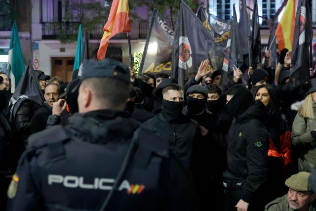 Masked demonstrators attend a demonstration called by Falange Espanola de las JONS fascist party in Madrid, on November 21, 2025, marking the 50th anniversary of Spanish dictator Francisco Franco's death. Prime Minister Pedro Sanchez yesterday called on Spaniards to defend the "miracle" of their democracy as the divided country marked the 50th anniversary of ex-dictator Francisco Franco's death. The general's demise on November 20, 1975 ended 36 years of authoritarian right-wing rule that followed a devastating 1936-1939 civil war which brought him to power. (Photo by Oscar DEL POZO / AFP)