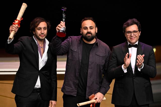 Amer Nasser and Rani Masiha receive on behalf of Palestinian directors and screenwriters Tarzan and Arab Nasser the Silver Pyramid Award for the film "Once Upon a Time in Gaza" during the closing ceremony of the 46th Cairo International Film Festival in Cairo on November 21, 2025. (Photo by Khaled DESOUKI / AFP)