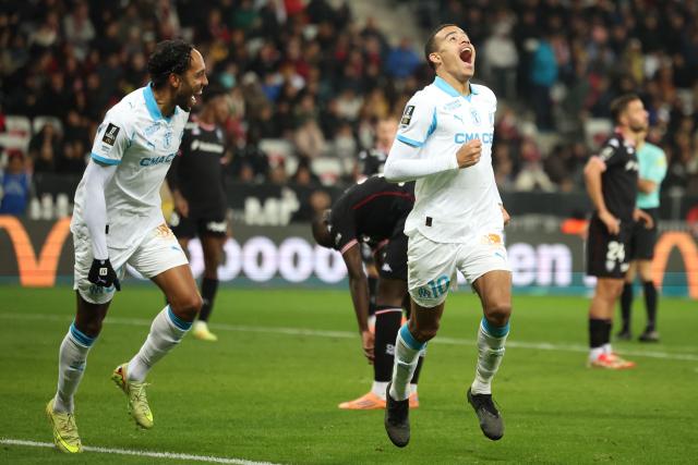 Marseille's English forward #10 Mason Greenwood (R) celebrates scoring his team's third goal during the French L1 football match between OGC Nice and Olympique de Marseille (OM) at the Allianz Riviera stadium in Nice, south-eastern France, on November 21, 2025. (Photo by Valery HACHE / AFP)